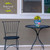Briarwood Lane small black metal table with colorful hydrangeas in ceramic pot on top.