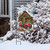Country Christmas Garden Flag with red truck, snow-covered house, and festive decorations on display outdoors.