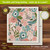 Blue and pink floral Swedish dishcloth with green leaves on a pink background, 6.75 x 7.5 inches.