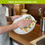 Pineapples and Leaves Swedish Dishcloth, white plate with tropical design, absorbent reusable kitchen cleaning cloth.