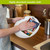 American Picnic Swedish Dishcloth, colorful, absorbent cloth drying a white plate in a kitchen setting.
