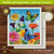 Butterfly Swedish dishcloth with colorful flowers and butterflies on a blue background, 6.75x7.5 inches.