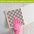 Pink and blue check Swedish Dishcloth, hand in pink glove holding decorative cleaning cloth.