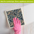 Paisley Swedish Dishcloth in blue and gold pattern being used on a surface with pink glove.