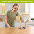 Woman placing Patriotic Gnomes Swedish Dishcloth on a kitchen counter, showcasing eco-friendly cleaning product.