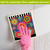 Bright Blooms Swedish Dishcloth with colorful floral design on a white surface with a hand.