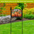 Country Pumpkins Acrylic Art Sign on black metal stand with three orange pumpkins and flowers.