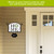 Home acrylic art sign with green wreath and house number 567 on black metal bracket.