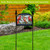 Wintertime Cardinals Acrylic Art Sign with three cardinals on a black stand in a garden.