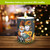 Fall Gnomes flameless candle with LED light on wooden table with autumnal gnomes design.
