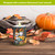 Fall Gnomes flameless candle with gnomes, sunflowers, and pumpkins on a dark green background.