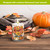 Autumn Arrangement Flameless Candle with floral design and fall leaves on a wooden table setting.