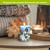 Checkered snowman flameless candle on table with cozy background and warm lighting ambiance.
