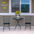Crated Mason Jars medium planter on outdoor table between two black metal chairs with yellow flowers.