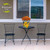 Medium Checkered Sunflowers Decorative Planter with sunflowers and orange flowers on a small outdoor table.