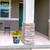 Hello Sunshine Medium Planter, colorful floral pot with yellow flowers on a porch.