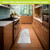 Slate Oversized Comfort Mat in a kitchen, rectangular gray mat on wooden floor beside stove.