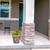 Farm Fresh Flowers medium planter with colorful flowers on a home's porch next to a pillar.