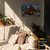Country Christmas Large LED Canvas Art on a wall above a couch with pillows and plants.