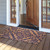 Blue damask coir doormat, 30 x 48, with tan background and blue floral pattern on wood porch.