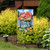 Garden flag with bunnies in a bucket of flowers, colorful blooms, and sunny floral design.
