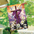 Sunrise Easter Cross House Flag with purple cloth, white lilies, and doves on a wooden pole.