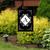 Black and white monogram garden flag with A, double-sided, decorative floral design on black background.