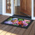 Perched Cardinals Doormat with colorful flowers and birds on a black background with decorative border.