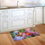 Perched Cardinals Doormat with colorful hydrangeas and vibrant cardinals on a kitchen floor beside cabinets.