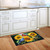 Birds in the Garden Doormat with sunflowers and birds on a kitchen floor with white cabinets.