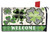Green shamrock patterned oversized mailbox cover with welcome text and black and white checkered details.