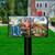In the Garden Mailbox Cover with colorful floral design, birds, and butterflies on a lawn.