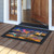 Oceanside Fireworks Doormat with colorful beach scene and fireworks display on a black background.
