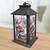 Black metal lantern with red, white, and blue floral design and American flags inside glass panels.