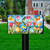 Sunshine Butterflies Mailbox Cover with colorful butterflies and tulips on a black mailbox in the yard.