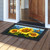 Sunflower Dance Doormat with yellow sunflowers, blue butterfly, and orange butterfly on wooden porch floor.