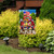 American Pickup Picnic Garden Flag with red truck, flowers, and American flag design outdoors.