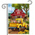 Yellow vintage truck with flowers, parked in front of red barn on garden flag.