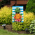 Pineapple and Stripes Garden Flag with blue, white, and pink floral design on display outdoors.