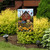 Sunflower Barn Garden Flag with vibrant red barn, sunflowers, and blue tractor design on garden stand.