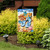 Welcome To the Beach Flip Flop Garden Flag with seashells and flip flops on display.