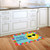 Hello Sun Summer Doormat with colorful border and smiling sun on wooden kitchen floor.