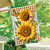 Sunflower Duo House Flag with yellow flowers, butterflies, and brown gingham accents on a wooden pole.