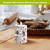Woodcut Floral white flameless candle with black floral design on a wooden table with bread.