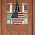 Wooden American Flag Door Hanger, round, red, white, and blue, hanging on a wooden door.