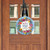 Bless This Home With Love Wood Door Hanger, round, floral, blue, hanging on wooden door.
