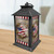American Barn Star Lantern with red, white, and blue star design on a wooden background.