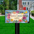 Bless This Home With Love Mailbox Cover with colorful flowers and butterflies on a lawn.