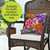 Zinnias in Bloom burlap indoor outdoor pillow with colorful floral design on wicker chair.