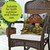 Sunflower Barn Indoor/Outdoor Pillow on a wicker chair with rural scenery print, brown and white.